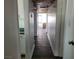 A hallway leading to a bright living room with wood accents and a neutral color palette at 1828 Hassett Ave, Las Vegas, NV 89104