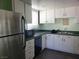 A well-lit kitchen with green countertops, white cabinets, and stainless steel appliances at 1828 Hassett Ave, Las Vegas, NV 89104