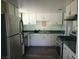 A well-lit kitchen with stainless steel appliances, white cabinetry and a gas range at 1828 Hassett Ave, Las Vegas, NV 89104