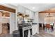 Efficient kitchen with white cabinets and stainless steel appliances, connecting seamlessly to the dining area at 1828 Hassett Ave, Las Vegas, NV 89104