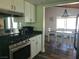Kitchen with stainless steel gas range, white cabinetry, and dining area view at 1828 Hassett Ave, Las Vegas, NV 89104