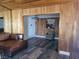 A living room featuring wood paneled walls, wood ceiling, and a comfortable reading nook at 1828 Hassett Ave, Las Vegas, NV 89104
