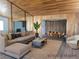 A living room featuring a large sectional sofa, wood paneled walls, and an open dining room at 1828 Hassett Ave, Las Vegas, NV 89104