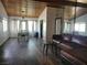 Spacious living room with hardwood floors, wood ceiling, and comfortable leather couch at 1828 Hassett Ave, Las Vegas, NV 89104