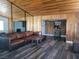 Bright living room with wood ceiling and hardwood floors, featuring a comfortable leather couch at 1828 Hassett Ave, Las Vegas, NV 89104