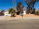 Exterior view of a single story home with desert landscaping and mature palm trees at 3688 Edison Ave, Las Vegas, NV 89121