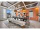 Modern dining room with large windows and a wood table with seating at 8620 Grove Mill Ct, Las Vegas, NV 89139