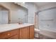 Bathroom featuring a vanity, a shower-tub combo, and a large mirror at 7457 Widewing Dr, North Las Vegas, NV 89084
