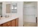 Bathroom with double sinks and a walk-in closet with wire shelving at 7457 Widewing Dr, North Las Vegas, NV 89084