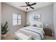 Cozy bedroom with a queen bed, plantation shutters, and a ceiling fan at 7457 Widewing Dr, North Las Vegas, NV 89084