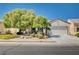 Charming single-story home with mature trees, well-maintained landscaping, and a two-car garage at 7457 Widewing Dr, North Las Vegas, NV 89084