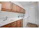 Laundry room with ample cabinet space, a sink, and a washer and dryer at 7457 Widewing Dr, North Las Vegas, NV 89084