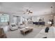 Bright and airy living room featuring a ceiling fan, neutral decor, and an open floor plan at 7457 Widewing Dr, North Las Vegas, NV 89084