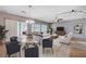 Spacious living room and dining area with ample natural light, ceiling fan, and tiled floors at 7457 Widewing Dr, North Las Vegas, NV 89084