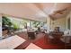 Covered patio with seating area, ceiling fan, and desert landscaping views at 7457 Widewing Dr, North Las Vegas, NV 89084