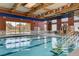Indoor swimming pool with marked lanes, a sauna, and large windows offering outdoor views at 7457 Widewing Dr, North Las Vegas, NV 89084