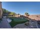 Landscaped backyard with putting green and brick pathway at 45 Moltrasio Ln, Henderson, NV 89011