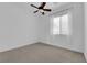 Bright bedroom with neutral carpet, ceiling fan, and window with white blinds at 45 Moltrasio Ln, Henderson, NV 89011