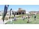 Golf club with players in action with a beautiful clubhouse and landscape at 45 Moltrasio Ln, Henderson, NV 89011