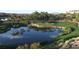 Scenic view of a lush golf course with a water hazard and palm trees reflecting in the water at 45 Moltrasio Ln, Henderson, NV 89011