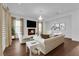 Bright living room boasts fireplace, hardwood floors, large windows, and stylish decor at 45 Moltrasio Ln, Henderson, NV 89011