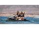 Gathering of three enjoying time together on a jet ski during a water activity at 45 Moltrasio Ln, Henderson, NV 89011