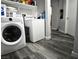 Bright laundry room, washer, dryer, and ample shelf space at 4657 Coronado Hills Way, Las Vegas, NV 89115