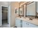 Main bathroom with double vanity and a large mirror at 8209 Crows Nest Ln, Las Vegas, NV 89128