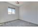 Spacious bedroom with grey carpet and a large window allowing natural light at 9807 Ravenstone St, Las Vegas, NV 89141