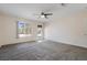 Spacious living room features a ceiling fan, neutral paint, and a door leading to the backyard at 360 E Kimberly Dr, Henderson, NV 89015