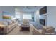 Bright living room features a fireplace, ceiling fan, plush carpet, and modern furnishings at 1200 Golf Club Dr, Laughlin, NV 89029