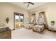 Well-lit bedroom featuring dual twin beds, a private balcony, and a cozy, inviting atmosphere at 1309 Imperia Dr, Henderson, NV 89052