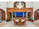 Luxurious dining room with chandelier, large windows, and city views at 1309 Imperia Dr, Henderson, NV 89052