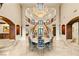 Elegant dining room with a chandelier, grand staircase, and views at 1309 Imperia Dr, Henderson, NV 89052