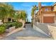 Long driveway leading to a grand home, featuring well-maintained landscaping and privacy at 1309 Imperia Dr, Henderson, NV 89052