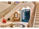 Elegant foyer boasts a curved staircase, decorative mirror, and marble accents at 1309 Imperia Dr, Henderson, NV 89052