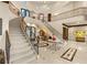 Elegant foyer features a sweeping staircase, marble floors, and detailed ironwork at 1309 Imperia Dr, Henderson, NV 89052