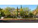 Elegant two-story home with lush landscaping, mature trees, and a circular driveway at 1309 Imperia Dr, Henderson, NV 89052