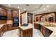 Spacious kitchen features dark wood cabinetry, granite countertops, and modern appliances at 1309 Imperia Dr, Henderson, NV 89052