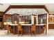Gourmet kitchen boasts dark wood cabinetry and granite counters with barstool seating at 1309 Imperia Dr, Henderson, NV 89052