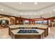Open kitchen features granite countertops, dark cabinets, and an island cooktop at 1309 Imperia Dr, Henderson, NV 89052