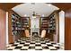 Cozy library with built-in bookshelves, a fireplace, and checkerboard flooring for a sophisticated ambiance at 1309 Imperia Dr, Henderson, NV 89052
