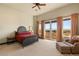 Bright main bedroom features a private balcony, a chaise lounge, and a serene, relaxing atmosphere at 1309 Imperia Dr, Henderson, NV 89052