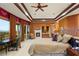 Spacious main bedroom suite with a fireplace, seating area, and balcony access, offering scenic views at 1309 Imperia Dr, Henderson, NV 89052