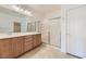 Bathroom with dual vanity, large mirror, and shower at 2088 Sawtooth Mountain Dr, Henderson, NV 89044