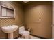 Stylish powder room with unique patterned wallpaper, pedestal sink, and modern fixtures at 2700 Las Vegas Blvd # 2702, Las Vegas, NV 89109