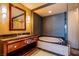 Bathroom features a dual sink vanity with soaking tub and tiled walls at 2700 Las Vegas Blvd # 2702, Las Vegas, NV 89109