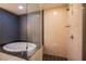 Bright bathroom with a soaking tub and glass enclosed shower at 2700 Las Vegas Blvd # 2702, Las Vegas, NV 89109