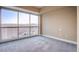 Bright bedroom with floor-to-ceiling windows offering city views and plush carpeting at 2700 Las Vegas Blvd # 2702, Las Vegas, NV 89109