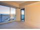 Bedroom with floor-to-ceiling windows offering stunning city views and neutral carpeting at 2700 Las Vegas Blvd # 2702, Las Vegas, NV 89109